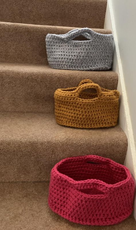 This crochet basket fits perfectly on the run of a stair.Pattern is one size (26 x 13cm) but can be adjusted using more or less increases and row for different sized baskets.This basket is made crocheting 2 strands of chunky/ bulky yarn together at the same time.This pattern makes an oval shaped basket with handles.This is an intermediate level crochet pattern.The stitches you need to know are single crochet, half double crochet, chain stitch, slip stitch. Storage Basket Ideas, Stair Basket, Crochet Chain Stitch, Baskets Diy, Crochet Lace Shawl, Crafting Corner, Crochet Rug Patterns, Crochet Chain, Basket With Handles