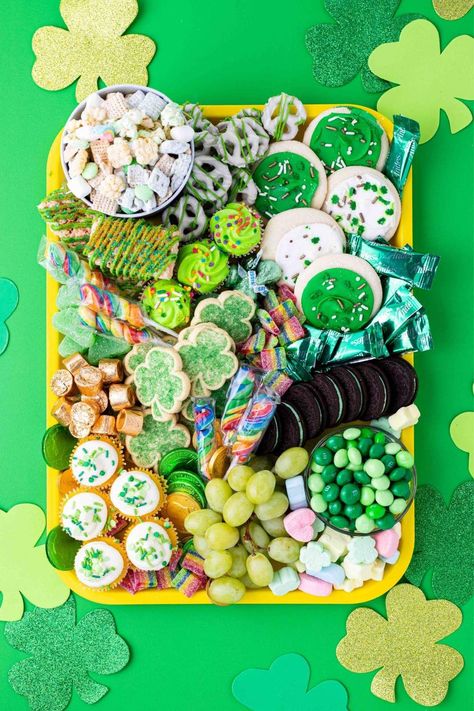 Looking for a fun and festive way to celebrate St. Patrick's Day? Why not try creating a St.Patrick's Day charcuterie board? St Patrick's Day Charcuterie Board, Green Popcorn, White Chocolate Covered Pretzels, Shamrock Cookies, Chicken A La King, Lucky Charms Marshmallows, Andes Mint, Fruit Chews, Mint Oreo