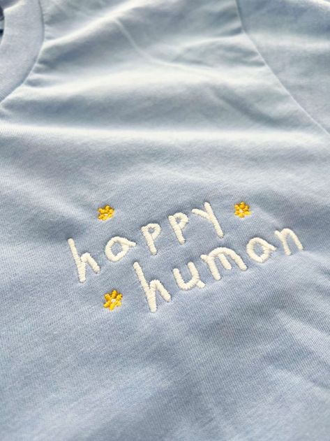 Our 'Happy Human' embroidered cotton tee is made with 100% cotton air-jet spun yarn for a soft and comfy fit. Unisex Fit. #embroideredshirt #embroideredtee #embroideredtshirt #embroideredtees #embroideredshirts #embroideredtshirts #womensembroidered #embroidery #womenstee #womentshirt #womentees #embroideredtshirts #shirtembroidered #teeembroidered #tshirtembroidered #cutetshirt #cutetee #cutetshirts #cutetees #aesthetictshirt #girlstee #girlstshirt #giftforher #giftforgirlfriend #giftforfriend Casual Embroidered Text T-shirt As Gift, Trendy Embroidered Text T-shirt For Everyday, Affordable Casual T-shirt With Embroidered Text, Casual T-shirt With Embroidered Text, Casual Oversized T-shirt With Embroidered Text, Mental Health T Shirts, Embroidery Tshirt, Embroidered Tee, Aesthetic T Shirts