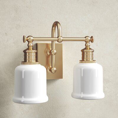 Fixture’s combination of strength and refinement is equally at home in a country manor or an urban apartment. We double-mount the sconce’s gooseneck arm to create a durable and appealing design. Bell-shaped glass, cast swivels, and straight-line knurling on the socket holders enhance vintage character. Color: Aged Brass | Birch Lane™ Larocque 2 - Light Vanity Light Glass in Yellow, Size 11.0 H x 13.5 W x 8.0 D in | Wayfair | Black Friday / Cyber Monday Deals Milk Glass Light Fixture Bathroom, Double Vanity Lighting, Modern Bathroom Design Lighting, Bathroom Vanity Lights, Country Manor, Urban Apartment, Light Fixtures Bathroom Vanity, Industrial Hardware, Bathroom Ceiling Light