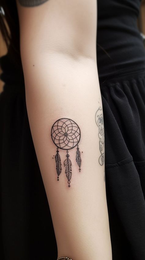 A striking tiny dreamcatcher tattoo, displaying an ornate webbed center, beads, and gracefully cascading feathers, encapsulating the essence of spiritual protection and good vibes. This diminutive design enables a discreet yet meaningful expression of personal beliefs, spiritual connection, and unique fashion. Small Dream Catcher Tattoo, Evil Eye Dream Catcher Tattoo, Small Dreamcatcher Tattoo, Dream Catcher Tattoo Design, Dream Catcher Tattoo, Small Dream Catcher, Latest Tattoos, Face Tattoos, Tattoo Trends