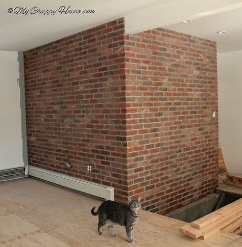 You use mortar just like a real brick wall because it IS a real brick wall - just thinner. I love how this turned out! See more at mycrappyhouse.com. Brick Paneling Ideas, Brick Veneer Panels, Diy Faux Brick Wall, Diy Brick Wall, Faux Brick Backsplash, Brick Wall Decor, Brick Accent Walls, Brick Face, Faux Brick Panels