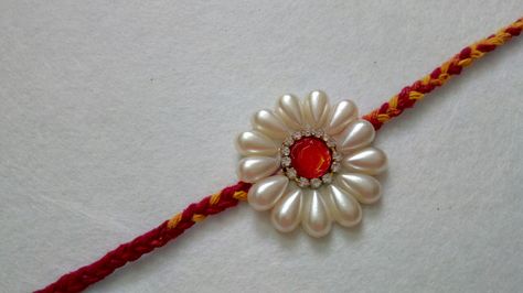 Pearl rakhi Rakhi Video, Home Made Rakhi, Hand Made Rakhi For School, Panchmasiyu Rakhi Design, Peacock Rakhi Design, Pearl Rakhi Handmade, Handmade Rakhi Designs, Rakhi Making, Silk Thread Bangles Design