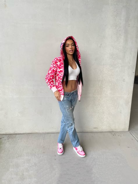 Light skin girl wearing a pink bape hoodie, white crop top , low rise jeans and pink bapesta sneakers. Pink Bape Outfit, Pink Bapestas Outfit, Pink Bape Shoes Outfit, Pink Bapesta Shoes Outfit, Outfits With Bape Shoes, Bape Shoes Outfits Women, Bapesta Hoodie, Hot Pink Hoodie Outfit, Pink Bape Jacket Outfit