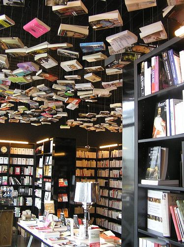 Floor to ceiling books! Hanging Books From Ceiling, Books Hanging From Ceiling, Whimsical Bookstore, Hanging Books, Luxury Home Library, Floating Ceiling, Quirky Books, Bookstore Design, Library Cafe