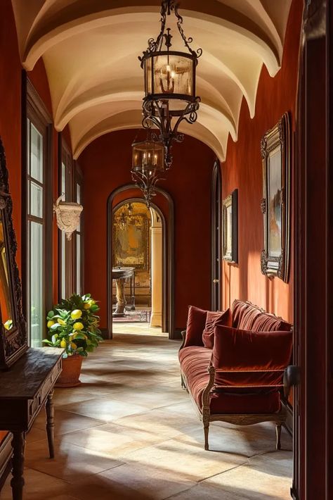 Opulent Italian entryway with warm lighting arched doorways wrought iron fixtures and curved console table with fresh flowers Burgundy Hallway Ideas, Arch Entryway Interior, Italian Entryway, Arch Hallway, Entryway Arch, Hallway Style, Curved Console Table, Curved Console, Hallway Design Ideas