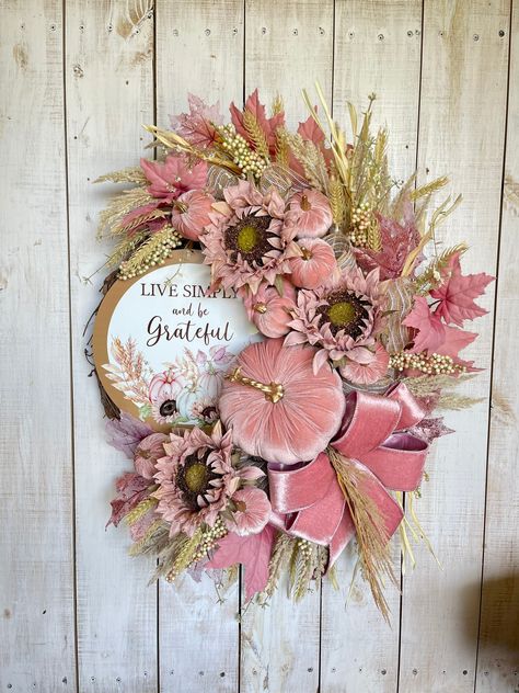 "Elegant Farmhouse Glam Fall Wreath for your front door porch entrance wall hanging holiday decor. Glittered Rose Gold Blush Pink Sunflowers & velvet Pumpkins.  Great for fall, autumn, thanksgiving door decorations. Farmhouse fall wreath door porch Decor. Grapevine base, Accented with Fall Florals, Pink glittered maple leaves, Pumpkins, Sunflowers, Berries, and rose blush pink Velvet bow.  Made on a round grapevine base, measures approx. 22\"- 24\"(H) x 8\"(D).  Indoor/Outdoor but for best longer lasting results display in a covered or protected area. Over time exposure to sun and weather may  cause some fading.... some materials more than others" Pink Fall Porch Decor, Pink Fall Decorations, Pink Fall Wreaths For Front Door, Pink Thanksgiving Decorations, Pink Pumpkin Wreath, Pink Fall Wreath, Blush Fall Decor, Pink Autumn Wedding, Pink Pumpkin Decor