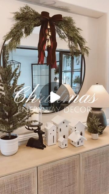 Nelly Irias | Arizona Interior Designer on Instagram: "Christmas Entryway Decor 🤎 These beautiful white houses are my favorite Christmas find this year!  . Mirror: 42x42 Stems: 4 Large + 2 Small . . Comment SHOP below to receive a DM with the link to shop this post 🔗 . . Christmas Entryway Decor - Burgundy Christmas Decor - Pottery Barn Christmas Decor - Entryway Mirror - Entryway Table - Elegant Christmas Decor - Modern Christmas Decor. #LTKchristmas #LTKcyberweek #mypotterybarn #potterybarn   ⬇ https://liketk.it/4XE2B #ltkseasonal #ltkhome #ltkholiday" Entryway Table With Lamp, Round Mirror Christmas Decor, Entry Way Table Christmas Decor, Christmas Mirror Decorations Ideas, Christmas Mirror Decor, Christmas Mirror Decorations, Console Table Christmas Decor, Christmas Entryway Table Decor, Christmas Entryway Table