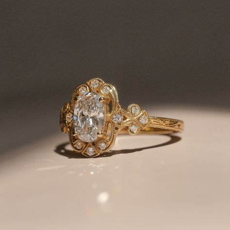 A ring inspired by an older era✨🦢 This 1.00ct oval lab-grown diamond is nestled in a beautifully handcrafted 18k yellow gold setting, featuring scrolling milgrain and diamond melee. A careful eye will appreciate the delicate hand-engraved swirls that gracefully crawl along the sides of the shank. Available online or in-store❤️‍🔥 Victorian Wedding Ring, Victorian Diamond Ring, Delicate Engagement Ring, New Victorian, Engagement Ring Yellow Gold, Vintage Wedding Ring, Vintage Inspired Engagement Rings, Dream Wedding Ring, Victorian Engagement Rings