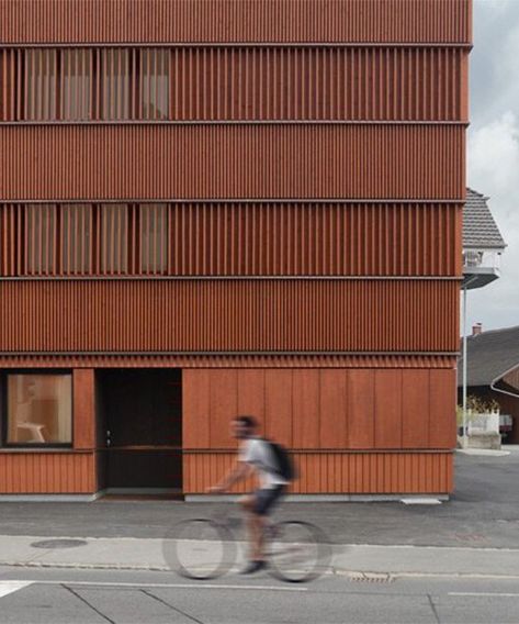 rusty red wooden guesthouse by ludescher + lutz revitalizes rhine valley town in germany Wood Facade Architecture Design, Wooden Apartment Building, Brick And Wood Facade Architecture, Red Facade Architecture, Casa Cook Hotel, Mass Timber Architecture Facade, Casa Cook, Wooden Facade, Wooden Buildings