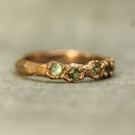 Handcarved mermaid treasure band inspired by the ocean with golden bubbles surrounding beautiful, sage green sapphires. solid 14k rose gold approx 4mm at the widest point 5 x approximately 2.5mm round sapphires one of a kind ready to ship in a size 6 3/4 this ring can be sized, so please message us for details Sage Green Jewelry, Ocean Rings, Earthy Rings, Emerald Ring Design, Gold Band Engagement Rings, Mermaid Treasure, Green Jewellery, Ocean Ring, Mermaid Ring