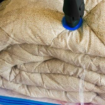 5 Tips on How to Store Bedding | Family Handyman Store Bedding, Comforter Storage, Swamp Cooler, Cedar Boards, Extra Shelf, Plastic Bins, Family Handyman, How To Store, Blanket Storage