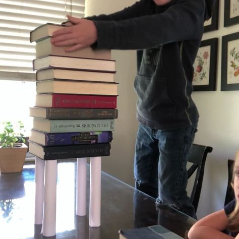 Fun STEM Engineering challenge for kids! Build a tower of books on 4 rolls of paper. How many can it hold? #stem #engineering #stemproject #papertower Ceiling Challenge, Paper Helicopter Template, Paper Tower Challenge, Stem Towers, Kids Science Museum, Paper Bridge, Paper Tower, Engineering Challenges, Homeschool Stem