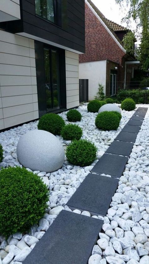 a modern front yard with large rocks and dark tiles for a contrast, greenery balls and oversized stone ones for bold landscaping Garden Landscaping Design Ideas, Front Yard Decor, River Rock Landscaping, Modern Front Yard, Landscaping With Large Rocks, Rock Garden Landscaping, Front House Landscaping, Home Landscaping, Front Yard Garden