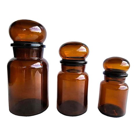 Offered is a set of three vintage Belgian glass apothecary bottles with mushroom top stoppers. The stoppers have rubber bases and around the lower edge to close the bottles tightly and avoid contamination. While these may have been used in apothecary stores, they are also lovely for use in the kitchen to store spices, teas, and coffee.   They measure Large 3.75" diameter, bottle is 6.5" tall, with stopper 8.5" tall Medium 3.25" diameter, bottle is 5.25" tall, with stopper 7" tall Small 2.75" dia Apothecary Bathroom, Apothecary Shoppe, Applique Art Deco, Apothecary Design, Apothecary Pharmacy, Apothecary Decor, Bathroom Canisters, Brown Bottles, Glass Spice Jars