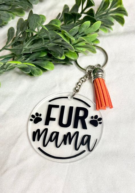 If you are lucky enough to love on dog then then these keychains are for you! Display your love for your pet with this Fur Mom and Dog Mom keychains! They are perfect to add to any set of keys, key fobs, lanyards, bags, purse, backpack and more!  Choose between 8 designs and pick between 17 different tassel colors.   *these do come in black permanent vinyl but if you would like another color just let me know* [Materials:] 2 inch acrylic disc 2 inch keychain Black permanent vinyl 1.5 inch faux suede tassel Currently cream colored tassels are sold out and unavailable [Care:] Acrylic keychains should be gently wiped with a dry cloth. [Shipping and Processing:] Please allow 1-3 business days for your order to be processed and shipped. Orders are shipped USPS First-Class with a tracking number. Sayings For Cricut Projects, Cricut Crafts To Sell At Craft Fair, Cricket Keychain Ideas, Cricut Key Chains, Cricut Keychain Ideas Vinyl, Circle Acrylic Keychain Ideas, Circle Keychain Ideas, Craft Show Ideas To Sell, Vinyl Ideas To Sell