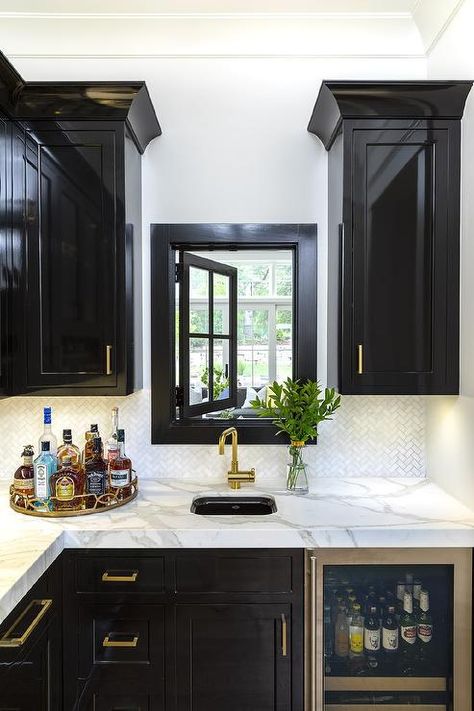 Glossy black wet bar cabinets accent brass pulls contrasted by honed white and gray marble countertops fitted with a curved wet bar sink. Kitchens With Black Cabinets, Wet Bar Cabinets, Wet Bar Sink, Marble Countertops Kitchen, Bg Design, Black Kitchen Cabinets, Home Bar Designs, Modern Farmhouse Bathroom, Interior Windows