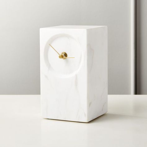 Shop Desi White Marble Table Clock. Brass hands keep time on solid honed white marble pillar. Minimal form allows luxe materials to really shine. Clock makes a handsome desk accessory, chic and practical bookend or thoughtful gift. CB2 exclusive. Marble Tables Living Room, Modern Wall Clocks, Marble Pillar, Retro Alarm Clock, Marble Clock, Marble Tables Design, Minimal Form, Marble Accessories, White Marble Table