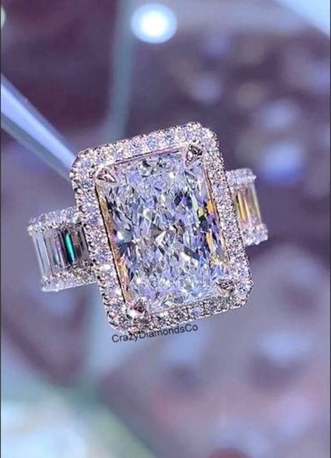 3.31 CT Radiant Cut Colorless Moissanite Diamond Ring, Halo with Baguette Diamond Pave Accents Wedding Ring, Anniversary Gift for Women ✹✹𝐖𝐞𝐥𝐜𝐨𝐦𝐞 𝐭𝐨 𝐂𝐫𝐚𝐳𝐲𝐃𝐢𝐚𝐦𝐨𝐧𝐝𝐬𝐂𝐨✹✹ Detail about stones Moissanite & Simulated Stone: ----------------------------- Stone Shape: Radiant Cut Stone Size: 10X7 mm Weight: 3.31 CT Color: Colorless Cut: Excellent Clarity: VVS ★ 𝑰𝒕𝒆𝒎 𝑫𝒆𝒕𝒂𝒊𝒍𝒔:- ☛ Metal Purity: Solid Gold (10KT, 14KT, 18KT); Silver(925 Sterling, 935 Argentium), 950 Platinum ☛ Metal Tone: Yellow, White, Rose ☛ Stamp/Hallmark: Yes ★ 𝑪𝒖𝒔𝒕𝒐𝒎𝒊𝒛𝒂𝒕𝒊𝒐𝒏:- ☛ Customized Design Jewelry. ☛ All cuts which you dream to make with moissanite. ☛ Updating every step of your ordered jewelry(Loose Stone, CAD & Making Process) ☛ All listed items in our stores are made to orde Etsy Engagement Rings Moissanite, Unique Ring Settings, Big Gold Rings, Radiant Diamond Ring, Big Diamond Engagement Rings, Big Wedding Rings, Fancy Diamond Ring, High Jewelry Ring, Cute Engagement Rings