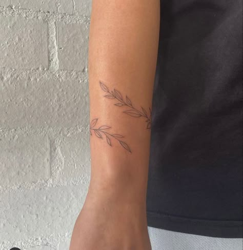 Dainty Wrap Around Arm Tattoo, Womens Arm Wrap Tattoos, Vine Tattoo Dainty, Dainty Vine Tattoo Wrist, Wrap Tattoos For Women Arm, Delicate Wrap Around Arm Tattoo, Simple Vine Wrap Tattoo, Leaf Wrap Around Tattoo Wrist, Small Arm Wrap Tattoo