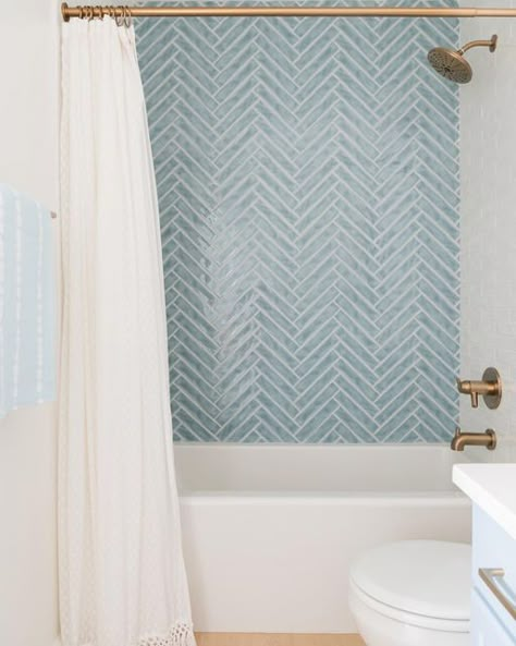 White Tub Blue Tile, Seaside Tile Bathroom, Fun Bathroom Shower Tile, Herringbone Tub Tile, Light Blue Herringbone Shower Tile, Shower Tile Blue Accent, Blue And White Bathroom Tile Ideas, Powder Blue Tile Bathroom, Gray Blue Shower Tile