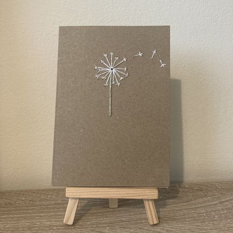 Beautiful handmade embroidered card. This A6 card features a minimalist, embroidered dandelion. The inside is blank for your message and the stitching is covered on the inside front.  Perfect for a thinking of you, sympathy card, birthday card and more occasions.   Envelope included.  Exact measurements of card are 10.5cm by 14.9cm. Sympathy Cards Handmade Simple, Embroidered Dandelion, Old Wood Projects, Embroidered Cards, Embroidered Paper, Sympathy Cards Handmade, Daisy Cards, Embroidery Cards, Stitching Cards