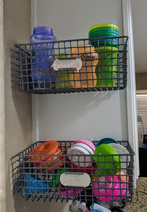 I went searching for a bottle organization idea that didn't take up counter space and would let me have separate areas for the new baby versus the toddler. Well, necessity is the mother of invention. When I didn't find anything, I purchased baskets from the At Home store and mounted them to the sides of my cabinet. On one side of the sink, we have baby bottles and on the other side of the sink, we have toddler sippy cups. Problem solved! Bottles organized and we got our counters back! 2 Under 2 Organization, Sippy Cup Storage Ideas, Toddler Cup Organization, Sippy Cup Storage, Sippy Cup Organization, Bottles Organization, Organized Nursery, Bottle Organization, Organization Baskets