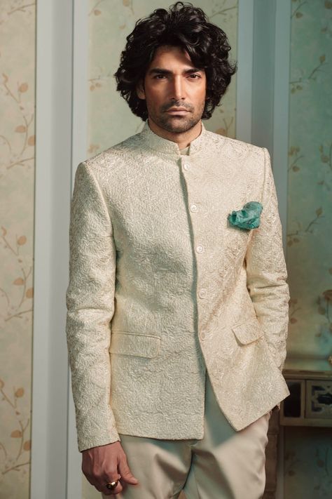 Inspired from exotic cultures, the #Bandhgala exudes royal extravagance. Spark the #celebrations with contemporary Bandhgalas from the #RaymondCeremonial collection!  The Ensemble: Self embroidered beige Bandhgala accessorized with an aqua blue pocket square. Beige Bandhgala, Reception Dress For Men, Raymond Shop, Indo Western Outfits For Men, Engagement Dress For Men, Formal Dress For Men, Wedding Outfits Indian, Blue Pocket Square, Modern Groom