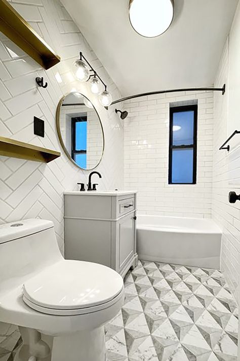 See how a total demo rescues this bathroom that had been untouched for years. Now, it’ll last for years to come. Dated Apartment, Gold Shelves, Coloured Grout, Apartment Projects, Striped Shower Curtains, White Subway Tile, Glass Partition, Marble Look Tile, Floral Shower Curtains