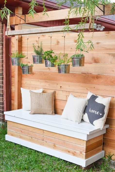 Build an outdoor storage bench with a twist – the hidden storage can hold two rubber totes! This backyard storage box is ideal for storing pool toys, kid’s outdoor toys, gardening tools, patio cushions, and more. I’m excited to share this DIY Outdoor Storage Bench. It’s both purposeful and beautiful. Having a storage bench that can withstand the weather is nice, but one that can hold a couple of sturdy totes and add style to our backyard? That’s functional! Here’s a video that show… Herb Chandelier, Outdoor Farmhouse Table, Diy Bench Seat, Diy Bank, Side Patio, Outdoor Bench Seating, Backyard Dining, Outdoor Farmhouse, Garden Bench Diy