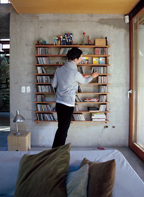 Hernaez organizes CDs on a modular lapacho wood shelf designed by Sticotti. Cd Shelves, Cd Rack, Cd Storage, Shelf Design, Furniture Designer, Book Shelf, Wood Shelves, Interior Spaces, Bookshelves