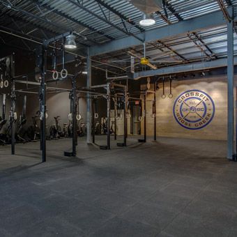 Shortly after purchasing the mats and before officially opening the doors to CrossFit Goose Creek, a gym owner from Nashville who was in a similar situation came over to witness the test.  “I was slamming a 135-pound barbell as hard as I possibly could from overhead,” Gray said, and the other gym owner said the sound was barely audible.  “We’ve been crashing weights on it for almost a month now, and I’ve been talking with my neighbors. They’re like, ‘We don’t hear anything,’” Crossfit Design Interior, Crossfit Gym Design Ideas, Crossfit Gym Design, Crossfit Box Design, Warehouse Gym Design, Crossfit Garage Gym, Rubber Gym Flooring, Warehouse Gym, Boutique Gym