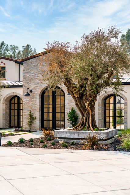 Modern Tuscan Architecture, Ranch Mediterranean Homes, Modern Spanish Home Exterior Mediterranean Design, Mediterranean Stone House Exterior, Santa Barbara Modern Home, Mediterranean Brick House Exterior, Landscaping Mediterranean Style, Mediterranean Exterior Design Style, Mediterranean Front Entrance