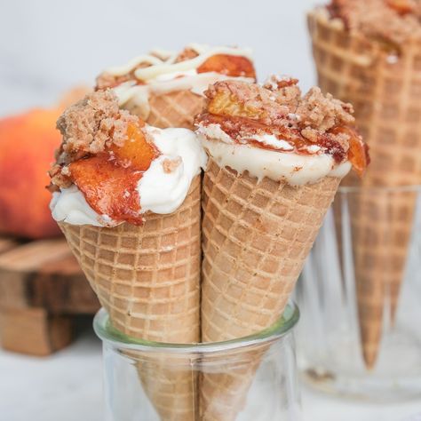 Peach Cobbler Cheesecake Cone Recipe Waffle Cone Filling Ideas, Waffle Cone Cheesecake Recipe, Peach Cobbler Cones Recipe, No Bake Cheesecake Cones, Waffle Cone Cheesecake, Peach Cobbler Stuffed Cones, Cheesecake Filled Waffle Cones, Waffle Cone Desserts, Peach Cobbler Cheesecake Cones