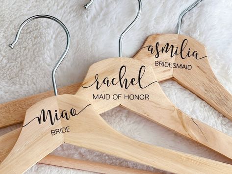 Our personalized hangers made from natural hardwood and permanently engraved with a laser. Dress up your wedding day with these beautiful engraved hangers. Personalized Bridesmaid Hangers, Engraved Hangers, Name Hangers, Bridesmaid Hangers, Wedding Hangers Personalized, Personalized Hangers, Dress Hanger, Wedding Hangers, Wedding Name