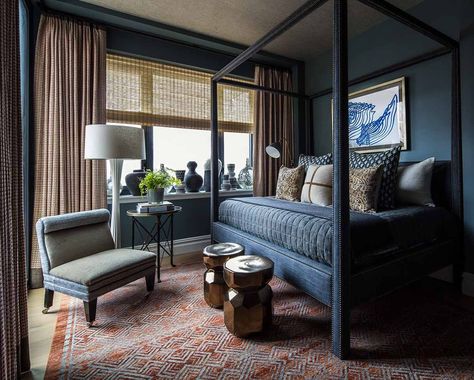 For the guest bedroom, Filicia settled on a custom four-poster bed dressed with bedding from Sedgwick & Brattle, Lucca Antiques and Barney’s Home. The wall color is Benjamin Moore's Steep Cliff Gray. The chair is from George Smith, the custom rug is from Patterson Flynn & Martin, and the drapery fabric is by Mila Blake. The floor lamp, garden stools, side table, and urns in the windows are all Sedgwick & Brattle by Thom Filicia. #moderndesign #layereddesign Steep Cliff Gray, Minimalist Bedroom Furniture, Guest Bedroom Design, Thom Filicia, Guest Room Design, Dark Bedroom, Guest Room Decor, Grey Gardens, Modern Bedroom Design