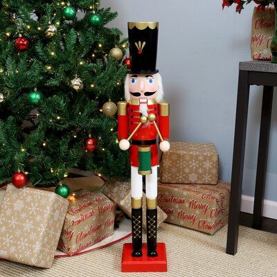 This nutcracker makes a great addition to your indoor winter holiday decorations. Constructed of wood and MDF, this decorative nutcracker is designed to replicate the classic look of traditional German nutcrackers. It will look great placed next to the Christmas tree, fireplace, staircase, and other areas inside your home. | The Holiday Aisle® Nutcracker Wood in Brown, Size 35.75 H x 7.75 W x 7.75 D in | Wayfair Drummer Nutcracker, German Christmas Decorations, Christmas Tree Fireplace, German Nutcrackers, Nutcracker Decor, Winter Holiday Decorations, Nutcracker Ornaments, German Christmas, Indoor Christmas