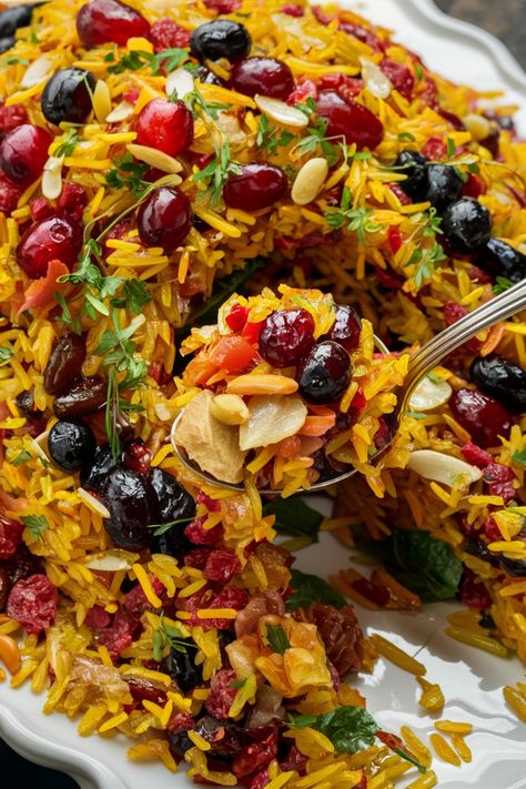 Colorful rice pilaf garnished with dried fruits, nuts, and herbs. Persian Cranberry Rice Pilaf, Jewel Rice Persian, Persian Rice And Chicken, Lebanese Hashweh Rice, Jeweled Rice Recipe, Jeweled Rice Persian, Middle Eastern Rice Dishes, Persian Dishes Recipes, Middle Eastern Rice Pilaf