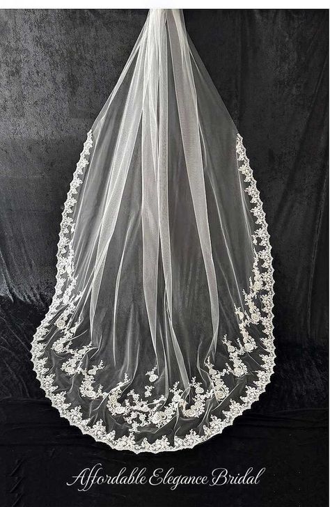 Royal Cathedral Lace Wedding Veil This exquisite 120" long royal cathedral length wedding veil is brought to you by JL Johnson Bridals. This romantic veil features ivory tulle and gorgeous floral lace at the edge beginning about 45" from the comb. In addition, a stunning row of lace appliques are inset on the bottom of the veil. This unique lace veil will ensure a dramatic walk down the aisle! Veil Size: 120" Long - Royal Cathedral wedding veil length. Colors: Ivory. Style: CF915. Please allow 1 week for delivery. Shipping Policy . Return Policy. Long Veils Bridal, Cathedral Length Wedding Veil, Cathedral Wedding Dress, Long Veils, Winter Wedding Accessories, Lace Cathedral Veil, Hair Veil, Bridal Veils And Headpieces, Cathedral Wedding Veil