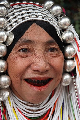 The smile. Akha woman from one of the hill tribes in Thailand wearing a wedding headress. Her teeth are stained from years of chewing on betel nuts.  ** Lily King, Betel Nut, Asian History, We Are The World, The Smile, Crown Hairstyles, People Of The World, Folk Costume, Interesting Faces