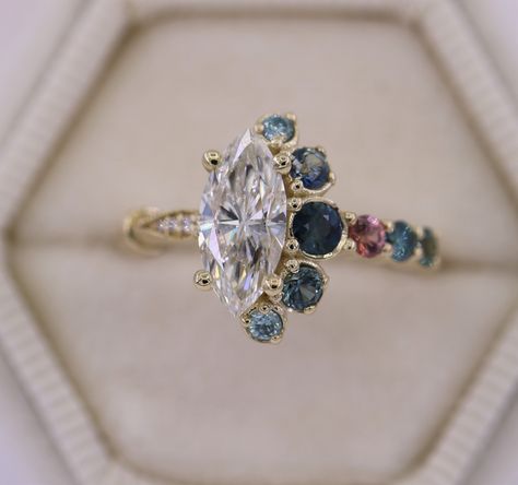 "This is a new level of the most unique engagement ring that combines 2 stunning styles Cluster+Vintage. The ring in the pictures features a 1.01 carat Marquise shape Diamond J color, SI2 clarity. Will come with Certificate. But If you want I can custom make this ring with a center Marquise FO Moissanite from Charles and Colvard. The Moissanite will be equivalent to a 1 carat diamond and will come with Certificate of Authenticity and Warranty. Please choose the center stone options from the drop Unique Gemstone Engagement Rings, Ombre Rings, Marquise Engagement Ring, Crescent Ring, Marquise Shape Diamond, Modern Engagement Rings, Engagement Rings Marquise, Unique Engagement Ring, Cluster Engagement Ring