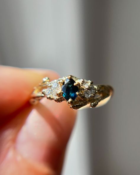 Have you met our new ONE-OF-A-KIND Feyre ring? She has the sweetest marquise cut teal blue sapphire and a cluster of natural diamonds ✨🌌 • • • • • #oliviaewing #oliviaewingjewelry #naturelovers #nature #naturejewelry #branchjewelry #forestjewelry #natureasthetic #cottagecore #cottagestyle #fairytale #fairyaesthetic #fairycore #acotar #feyre #fairylife #acotarjewelry #acourtofthornsandroses #acotafanart #fairytail #fairytale #lotr #lordoftherings #lordoftheringsjewelry #woodlandring #botani... Feyre Wedding Ring, Fairycore Ring, Acotar Ring, Feyre Ring, Acotar Feyre, Fairytale Engagement Rings, Ring Inspo, Traditional Engagement Rings, Night Court