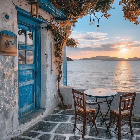 A quaint cafe corner with a stunning view of the sunset over tranquil sea waters. Quaint Cafe, Cafe Corner, Seaside Cafe, Seaside Sunset, Small Bakery, Sea Cliff, Cafe Ideas, Sunset View, Blue Door