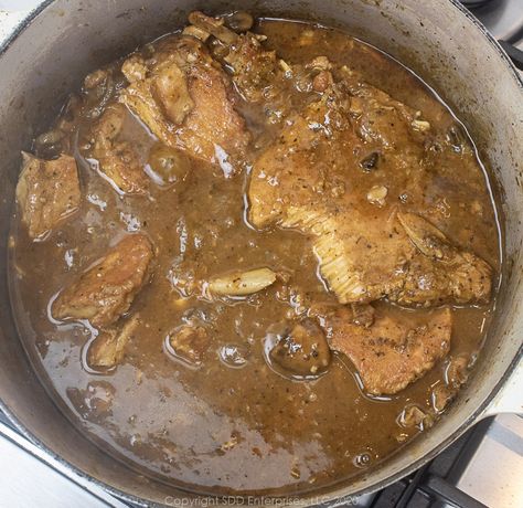 Cajun Smothered Pork Chops epitomizes Cajun cooking. Simple methods extracting every bit of flavor from the ingredients. Pork chops with Cajun seasonings are simmered slowly with onions in wine and stock until the pork is fork-tender and the gravy is thick and deep in flavor. Cajun comfort food at its best! Rice And Gravy Recipes Cajun, Cajun Cooking Recipes, Cajun Comfort Food, Cajun Seasonings, Pork Chops Smothered, Creole Food, Rice And Gravy, Pork Chops And Gravy, Potato Gravy