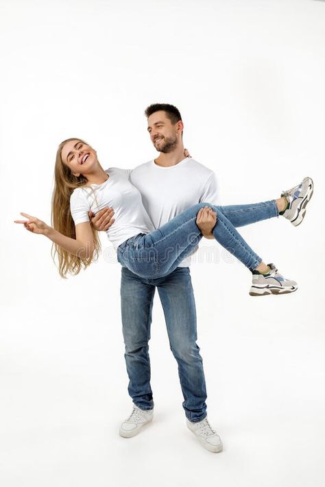 Man holding girlfriend on his arms. On white background royalty free stock photography Holding Someone In Arms Reference, Holding Girlfriend In Arms, Holding In Arms Reference, Holding Arms Out Reference, Holding Arm Pose Reference, Person Holding Hand Out, Arm Over Shoulder Pose Reference Couple, Holding Person In Arms Reference, Man Carrying Woman In Arms Aesthetic