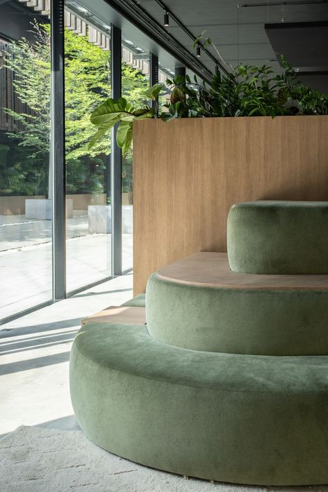 #architecture #interiorarchitecture #office #furniture #couch #green #industrial #velvet #plants #wood #concrete Green Accent Interior Design, Green Office Space, Sage Office, Platform Seating, Green Workspace, Concrete Lounge, Green Office Design, Pilates Studio Design Interiors, Reception Area Design