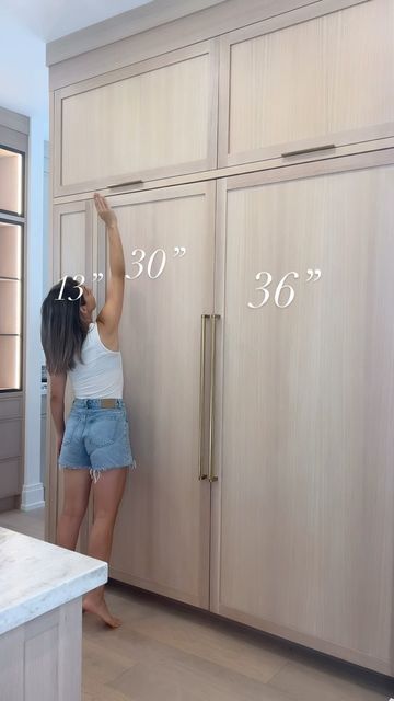 Laura Rustico II Building Beauty Full on Instagram: "You can really tell how short I am in this one 🙈

🤩Sharing our fridge / freezer panelled cabinetry wall. 

One thing I truly love about this wall is the 13” cabinet next to the fridge. It has become our go to place for snacks, everyday essentials and the kids love the easy access. 

I store away seasonal decor in the top two cabinets which include a single pull hardware and lift upwards for some design variety. 

Our fridge and freezer are panelled and overall, I’m really happy with choosing to panel them. I love waking up to the white oak look. 🍃

Here are the full dimensions

Panelled Freezer - 30” x 80”
Panelled fridge - 36” x 80”
Side cupboard- 13” x 80”
Upper lift Cabinets- 46” x 24”

All hardware is linked via https://liketk.it/ Diy Panel Fridge, Panelled Fridge, Panel Ready Fridge, Hidden Fridge, Side Cupboard, Castle Kitchen, Paneled Refrigerator, Panel Ready Refrigerator, Kitchen Cabinet Plans