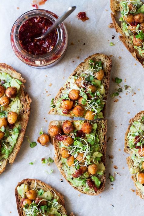 Vegan avocado toast with spiced chickpeas and sprouts is a super simple yet very nourishing meal that makes an awesome breakfast or lunch. It's gluten-free. Vegan Avocado Toast, Lazy Cat Kitchen, Brownie Cheesecake, Avocado Toast Recipe, Spiced Chickpeas, Toast Toppings, Toasted Bread, Toast Recipes, Vegan Breakfast Recipes