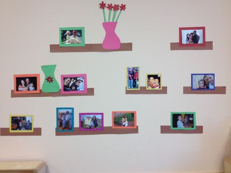 Just a great way to display children's family photos using construction paper and some imagination. I have it displayed in the classroom's  home living area! Family Theme Wall Decor, Family Photo Wall For Classroom, Family Photo Wall Kindergarten, Dramatic Play Wall Ideas, Ways To Display Family Photos In Classroom, Dramatic Play Wall Decor, Daycare Family Photo Wall, Dramatic Play Home Living, Family Photo Board For Classroom