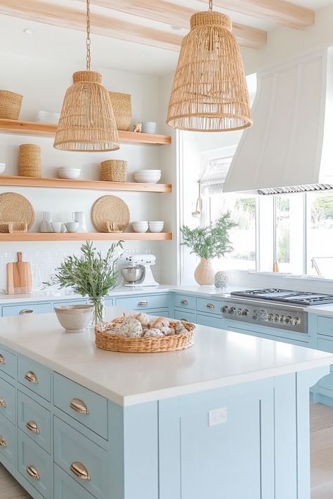 Discover the charm of the latest kitchen design with this serene coastal chic kitchen. Bright blue cabinets, wicker accents, and open shelving create a light, airy space perfect for cooking and entertaining. #kitchendesign #homedecor #coastalliving Boho Bright Kitchen, Light Blue Bottom Cabinets White Top, Coastal Kitchen Appliances, California Coastal Interior Design Kitchen, Grandmillenial Style Kitchens, Florida Kitchen Design, Coastal Farmhouse Kitchen Design, Grand Millennial Style Kitchen, Coastal Boho Kitchen Ideas